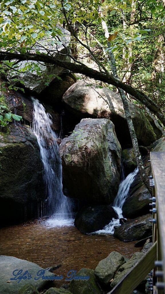 Waterfall running down between the rocks into a mountain stream