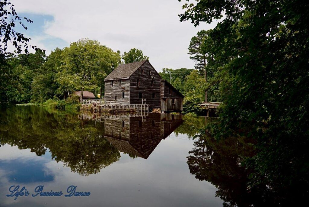 Historic Yates MIll reflecting with trees and blue-skys, on the mill pond,