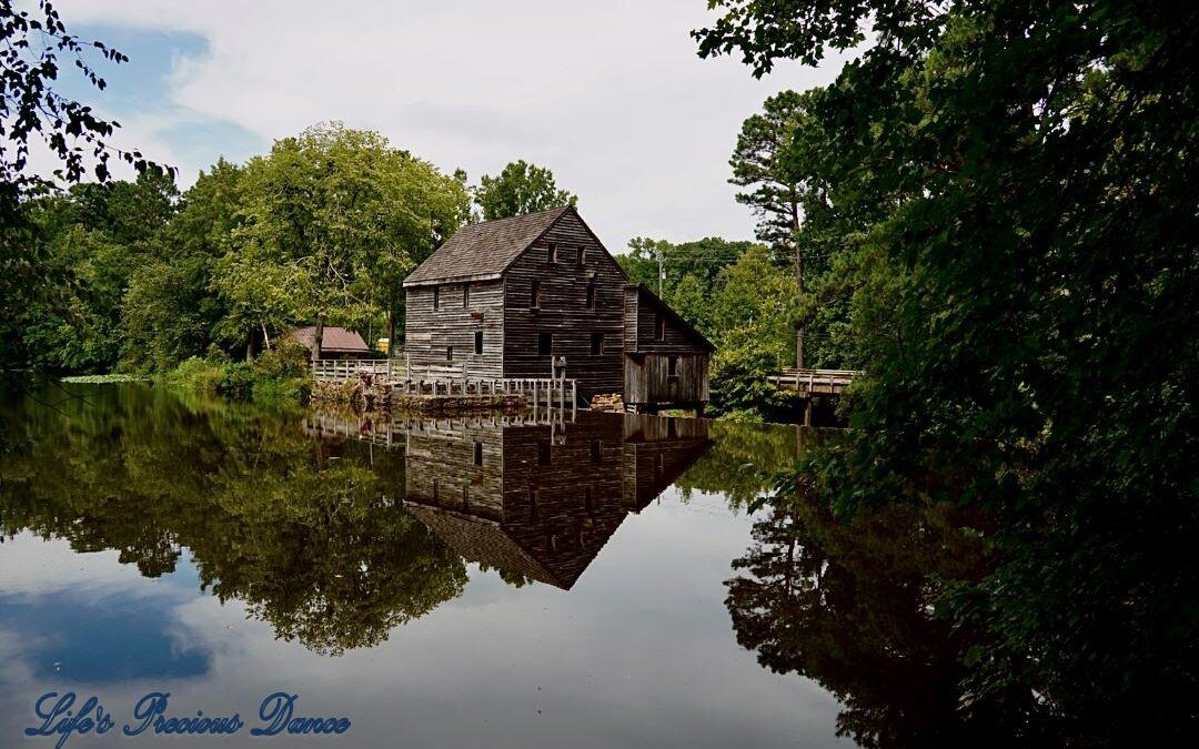 Historic Yates MIll reflecting with trees and blue-skys, on the mill pond,