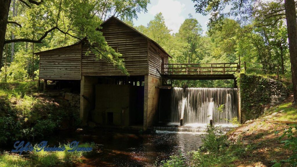 Beautiful Barfield Mill Pond on a gorgeous summer afternoon. Water flowing from the pond down into the creek below.