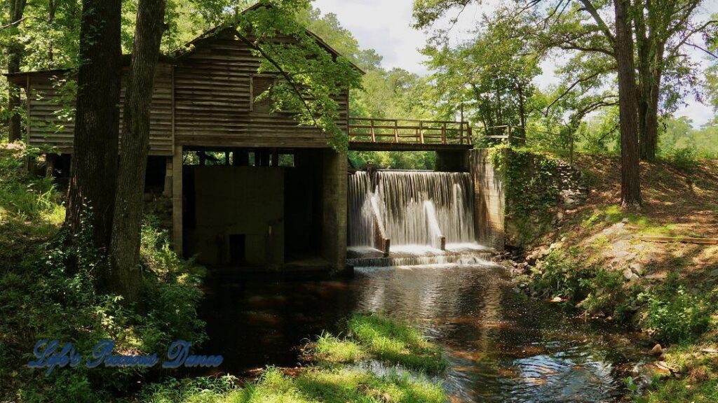 Beautiful Barfield Mill Pond on a gorgeous summer afternoon. Water flowing from the pond down into the creek below.