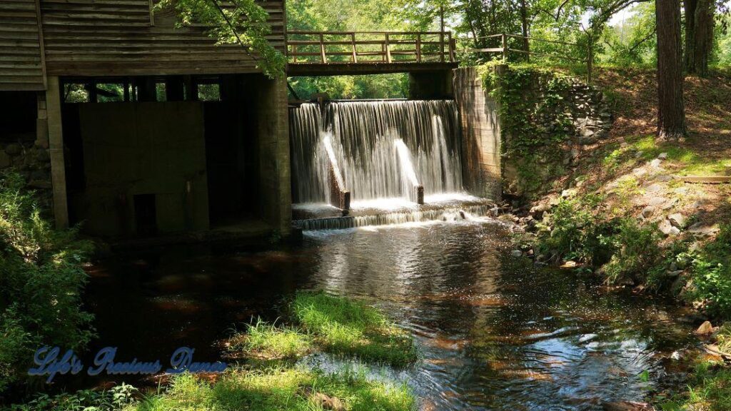 Beautiful Barfield Mill Pond on a gorgeous summer afternoon. Water flowing from the pond down into the creek below.