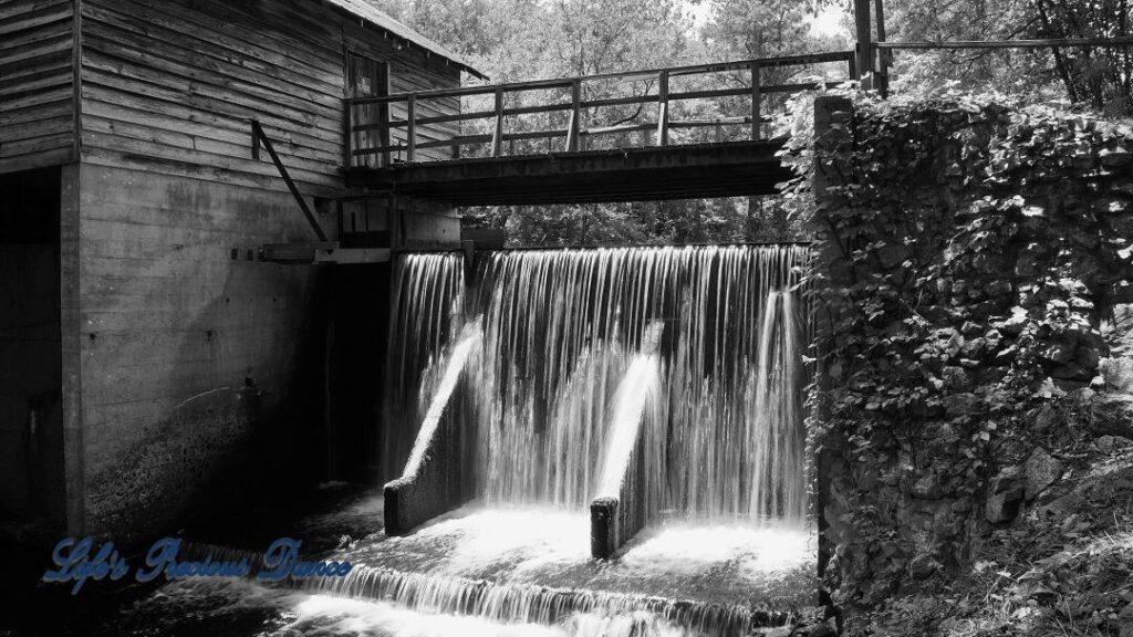 Beautiful Barfield Mill Pond on a gorgeous summer afternoon. Water flowing from the pond down into the creek below.