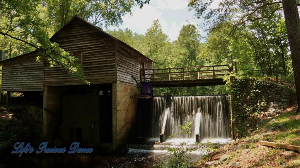 Beautiful Barfield Mill Pond on a gorgeous summer afternoon. Water flowing from the pond down into the creek below.