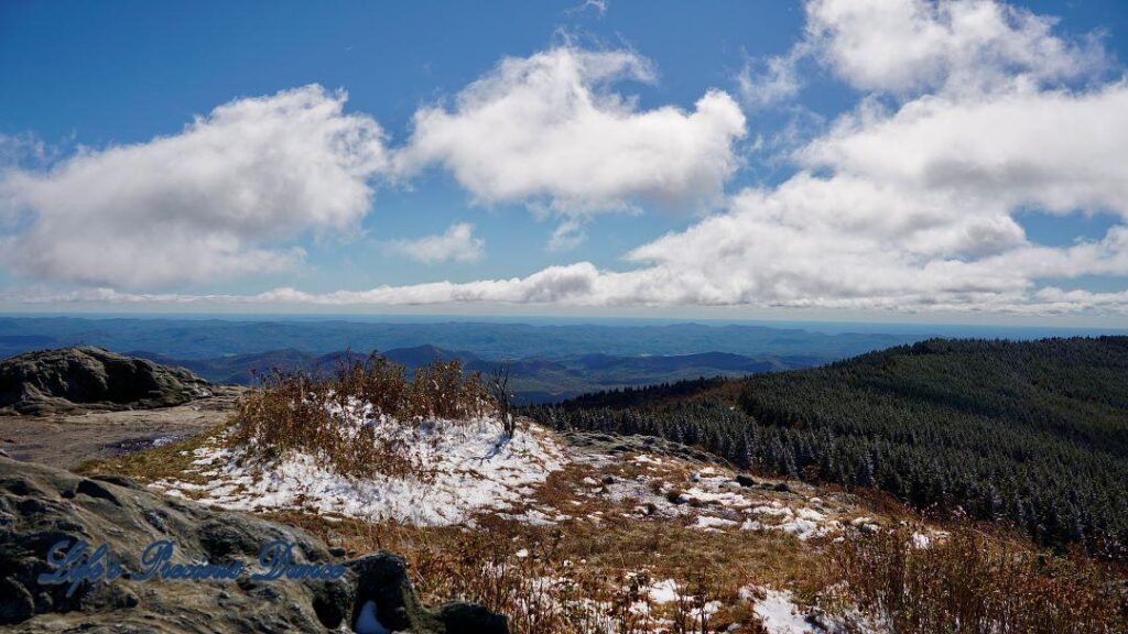 Snow covered mountain peak looking down into valley.