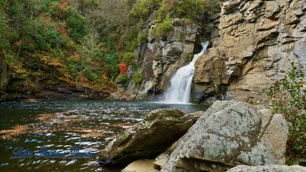 Linville Falls pouring down into the river basin. Rocks in foreground