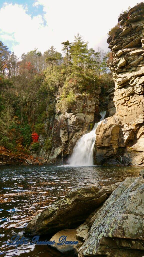 Linville Falls pouring down into the river basin. Rocks in foreground