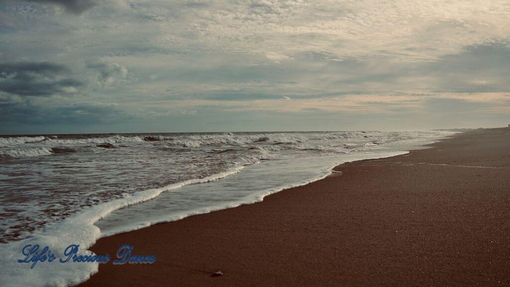 Waves crashing into shore on Pawley&#039;s Island. Storm clouds on the horizon.