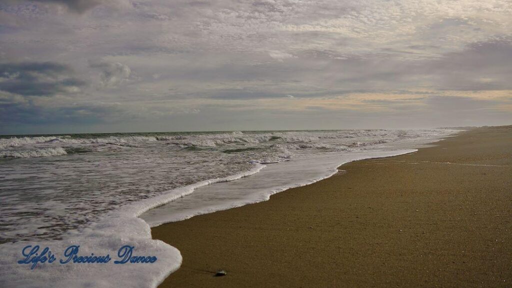 Waves crashing into shore on Pawley&#039;s Island. Storm clouds on the horizon.