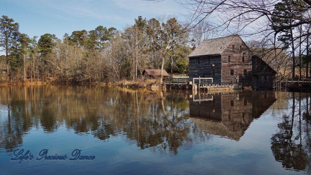 Yates Mill, clouds and surrounding trees reflecting in the pond.