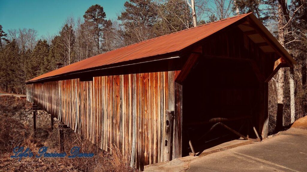 Side view of the rusting Ole Gilliam covered bridge.