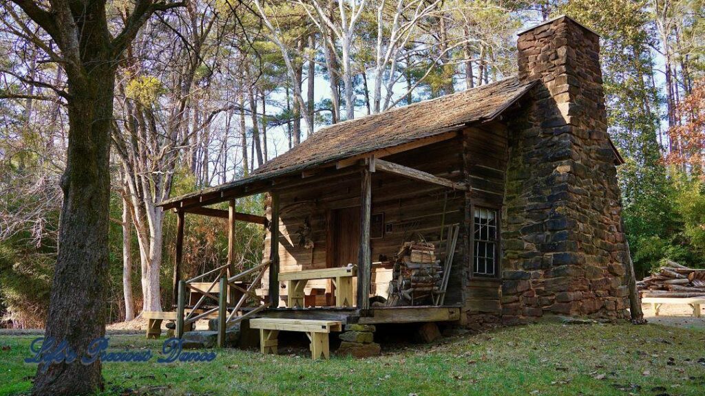 Side view of Historic McLendon Cabin revealing its rustic brick fireplace.