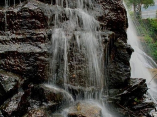 Reedy Falls spilling over rocks into the river below.