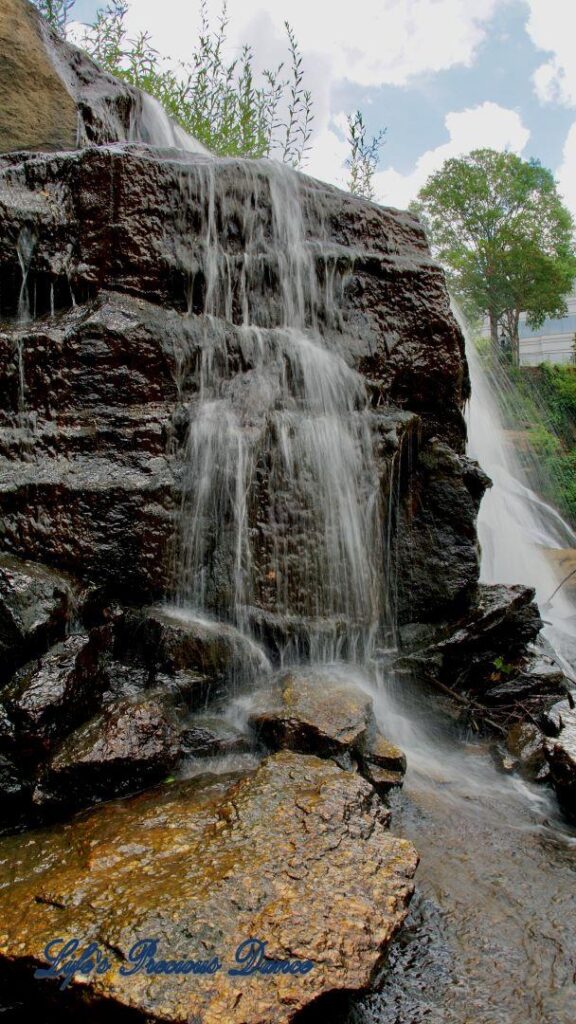 Reedy Falls spilling over rocks into the river below.