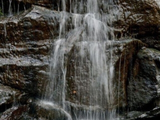 Close up of Reedy Falls spilling down a rock face.