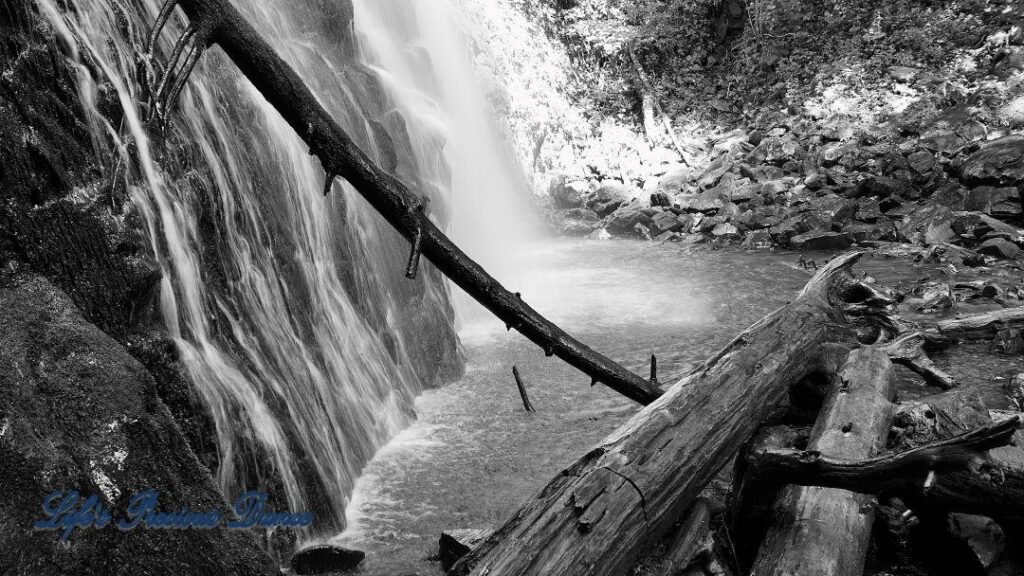 Up close black and white of Crabtree Falls spilling into a pool of water