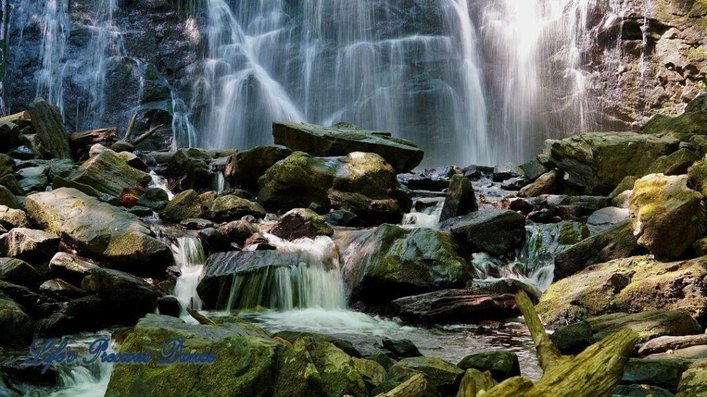 Mountain stream spilling through rocks. Crabtree Falls in background.