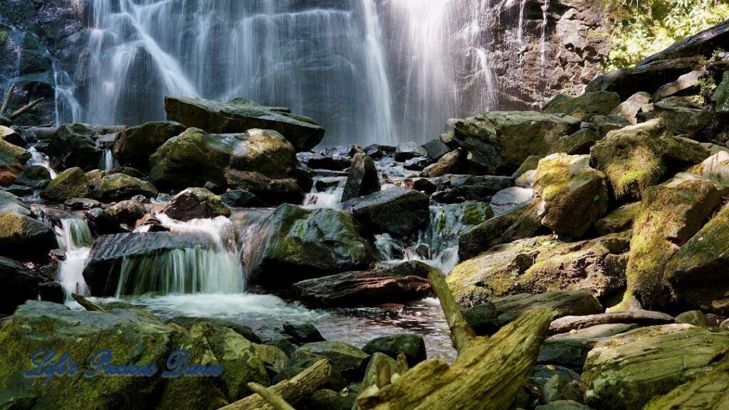 Mountain stream spilling through rocks. Crabtree Falls in background.