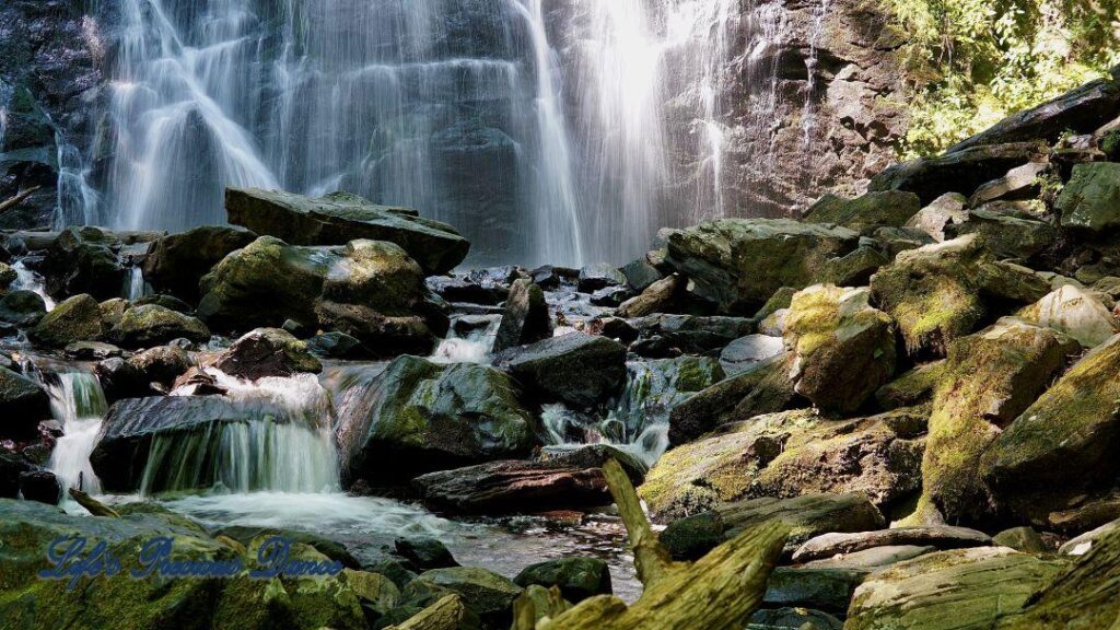 Mountain stream spilling through rocks. Crabtree Falls in background.