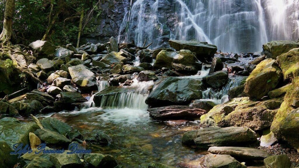 Mountain stream spilling through rocks. Crabtree Falls in background.