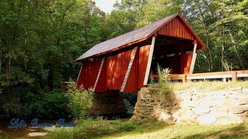 Front and side view of Campbell&#039;s Covered Bridge, spanning the creek.