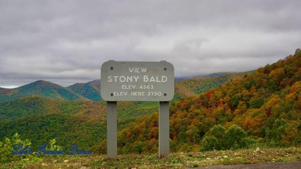 Landscape view of the colorful trees of the Blue Ridge Mountains. Overcast skies overhead.