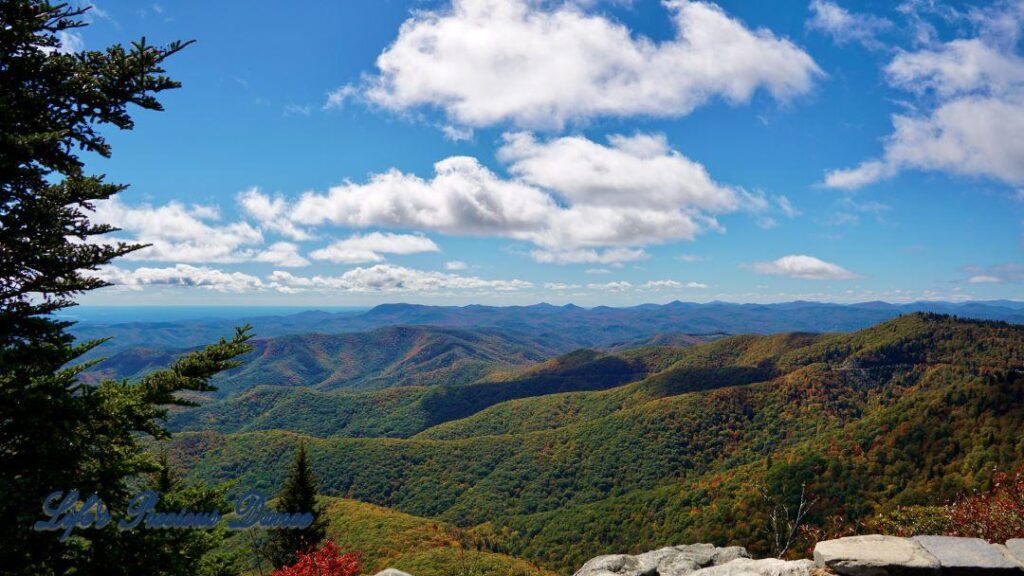 Landscape view of the colorful Blueridge mountains from Devil&#039;s Courthouse. Fluffy clouds overhead.