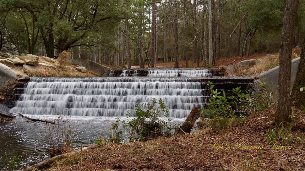 Two-tiered waterfall pouring into the creek below.