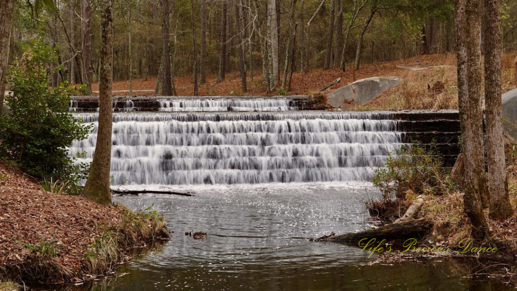 Two-tiered waterfall pouring into the creek below.