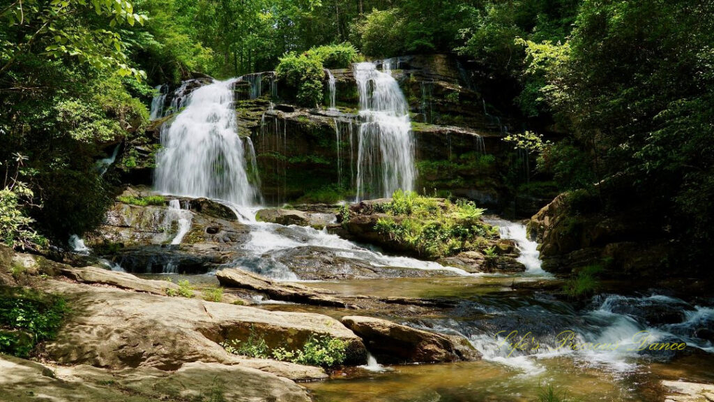 Long Creek Falls spilling over a moss covered rock ledge into the waiting creek below.