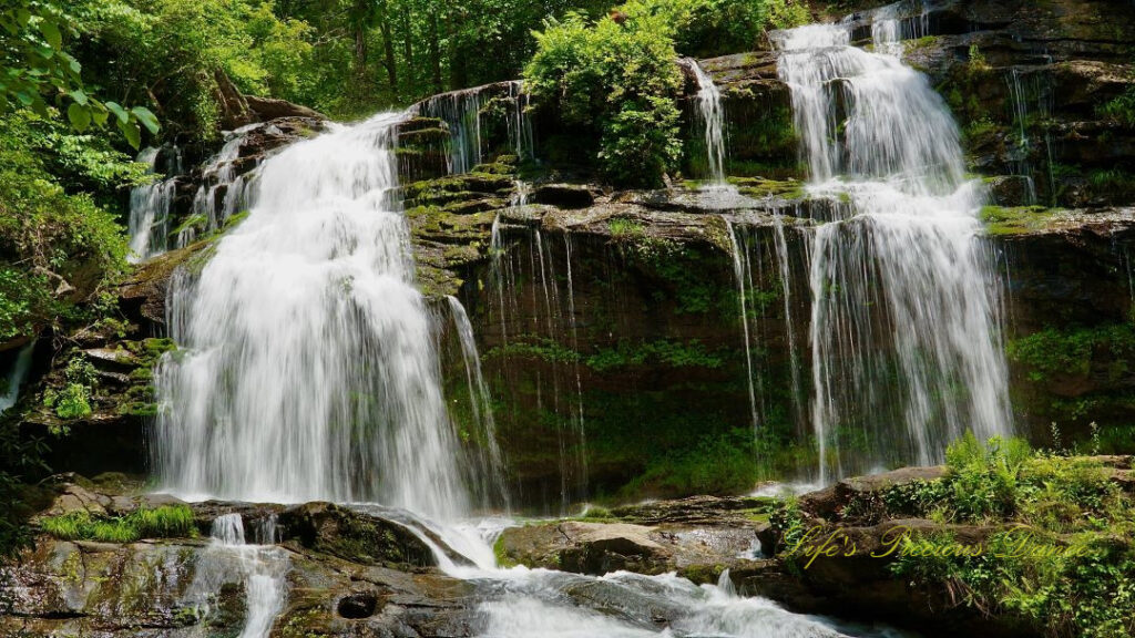 Long Creek Falls spilling over a moss covered rock ledge into the waiting creek below.