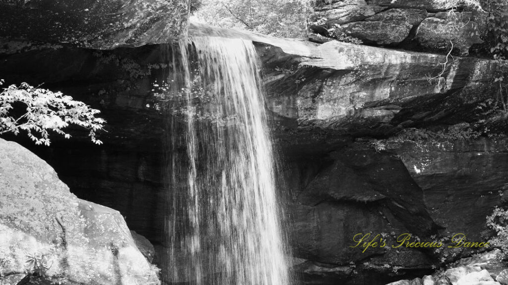 Black and white of top of Eagle Falls spilling over a rockledge.