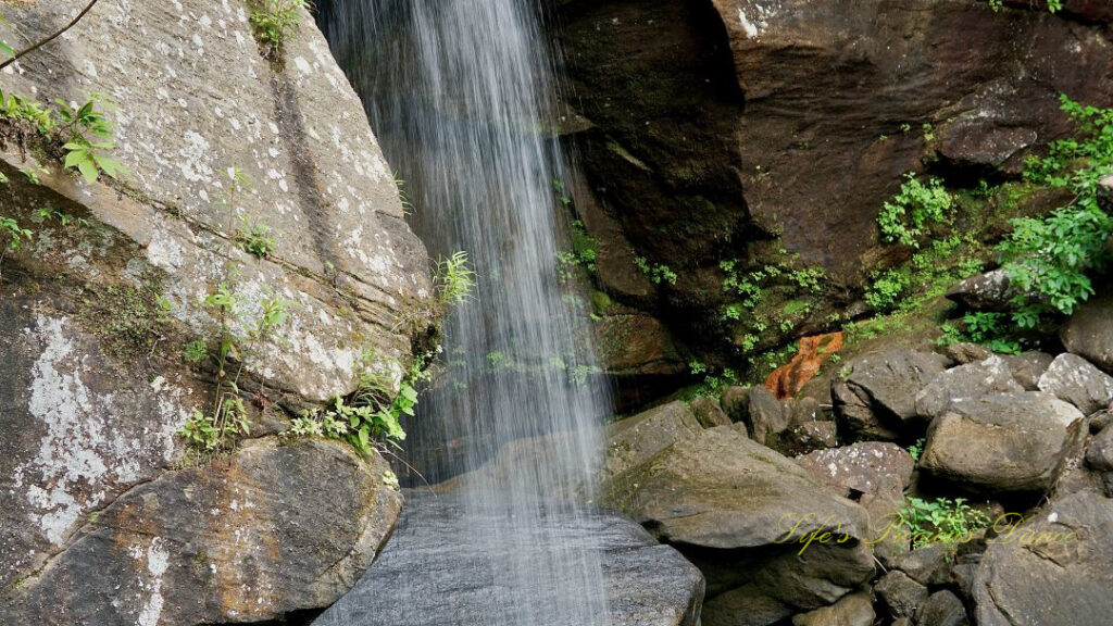 Close up of Eagle Falls spilling in front of rockface.