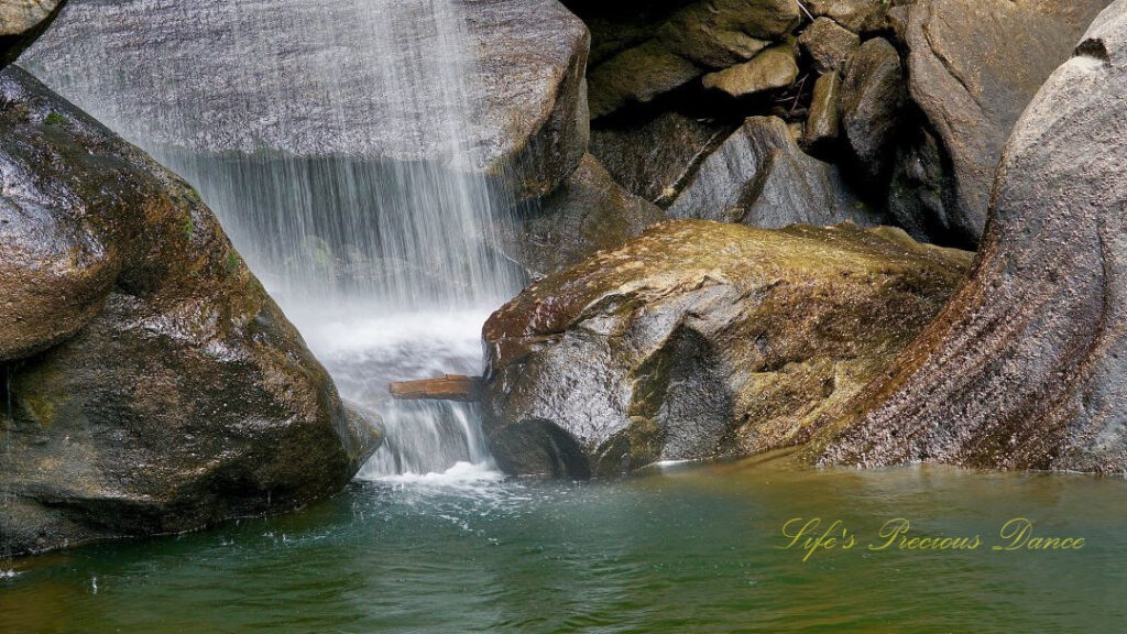 Close up of the base of Eagle Falls. Rocks glistern in the sunlight.