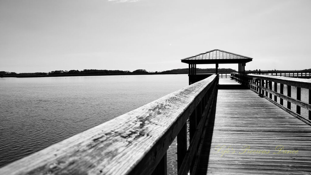 Black and white of a pier along the Beaufort River at Sands Beach.