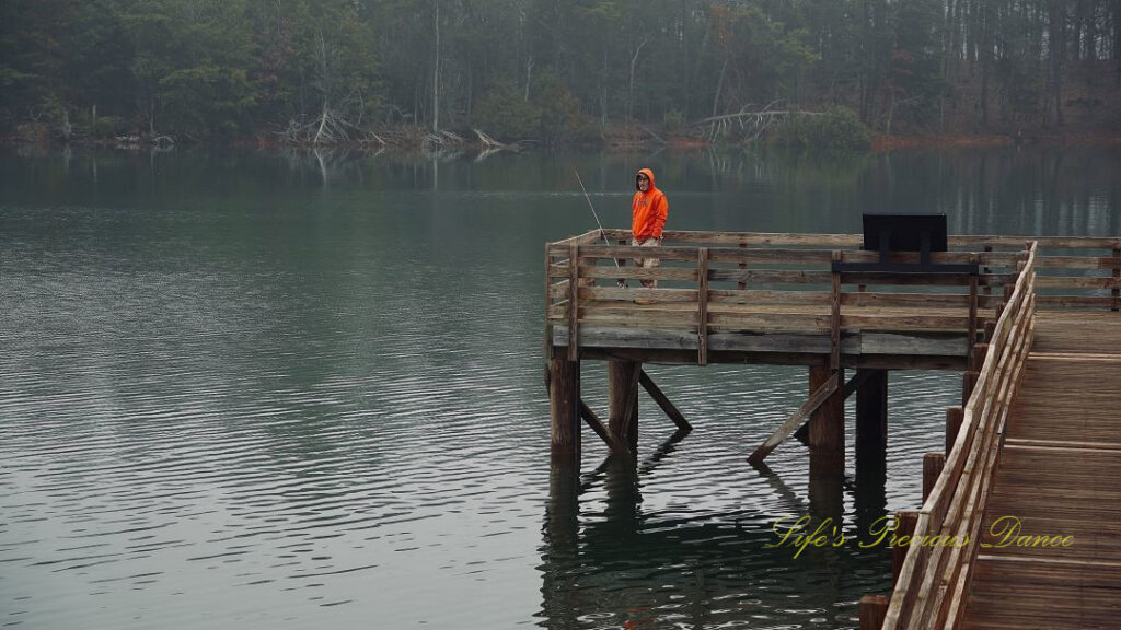 Man fishing from a pier at Sadlers Creek State Park.