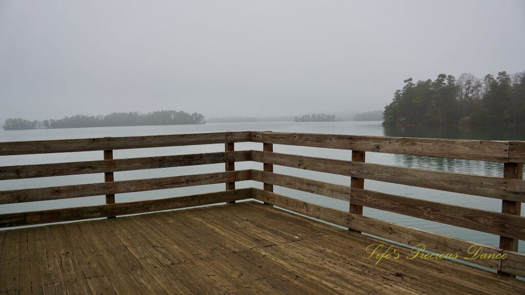 Corner of a pier overlooking a foggy Lake Hartwell.