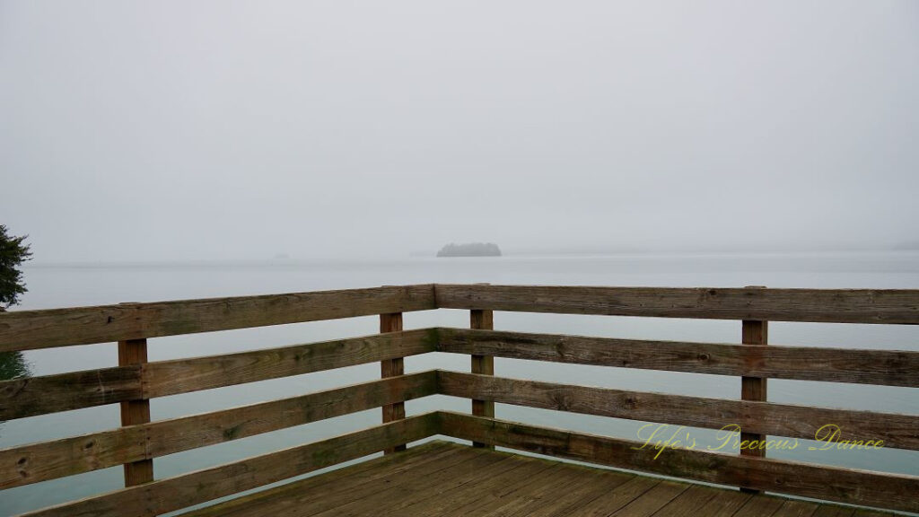 Corner of a pier overlooking a foggy Lake Hartwell.