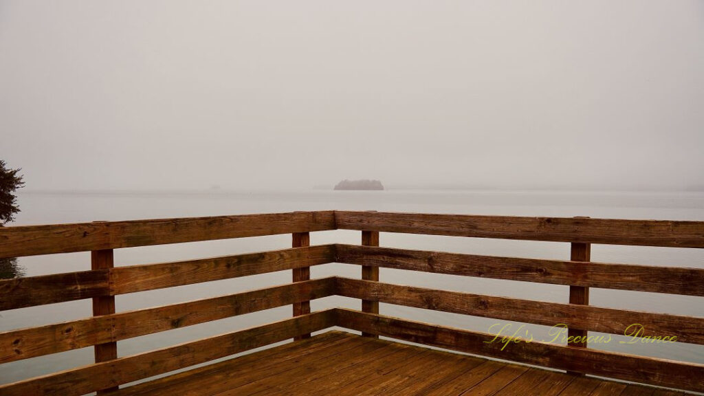 Corner of a pier overlooking a foggy Lake Hartwell.