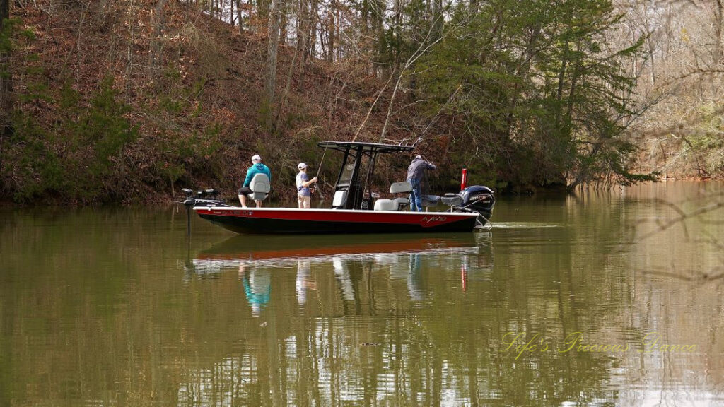 Close up of fisherman on a boat, reflecting in the water at Lake Hartwell.