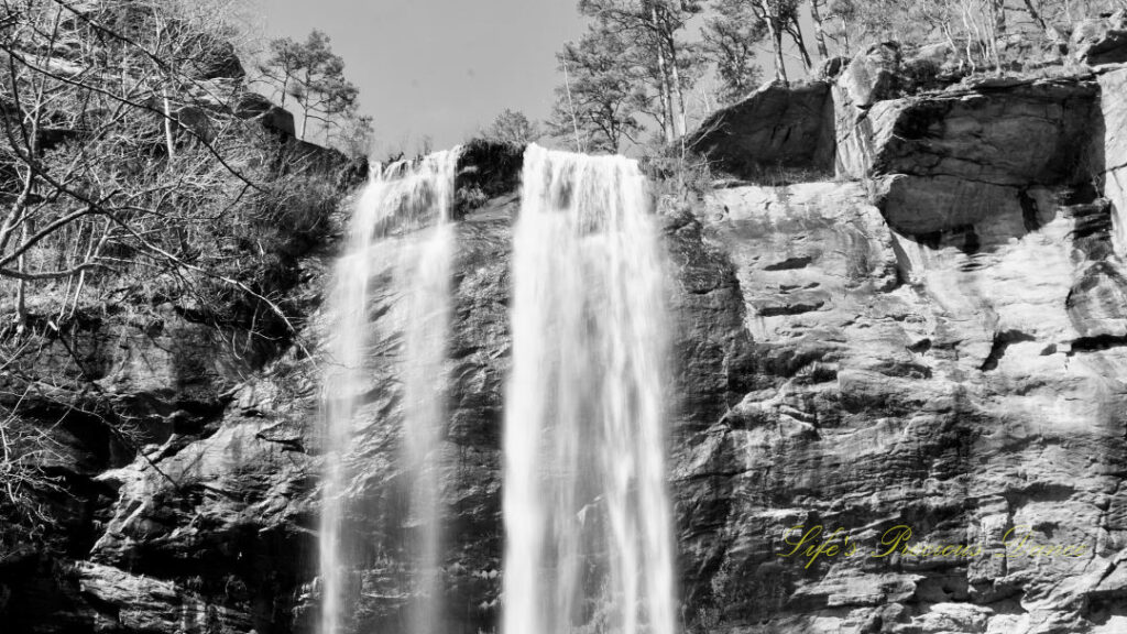 Black and white close up of the top of Toccoa Falls spilling over the rock ledge