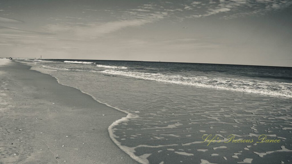 Black and white of waves rolling in at Huntington Beach.