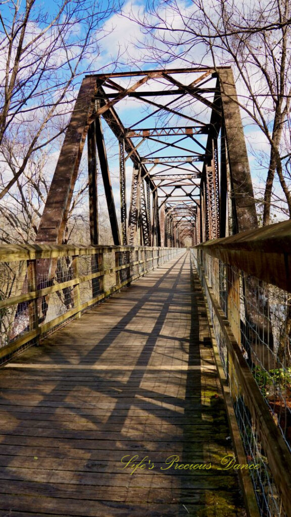 Straight on view of an old train trestle turned walking bridge.