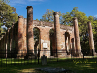 Front view of the Old Sheldon Church ruins. A lone tombstone stands in the foreground.