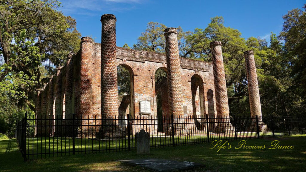 Front view of the Old Sheldon Church ruins. A lone tombstone stands in the foreground.