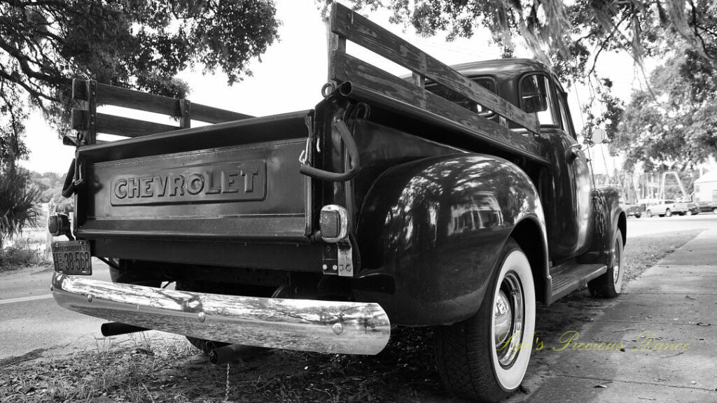 Black and white close up of the rear and back right corner of a 1953 Chevrolet 3100 truck.