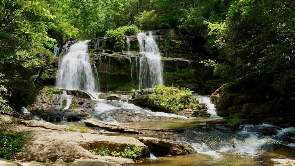 Long Creek Falls spilling over a rock ledge into the waiting creek below.