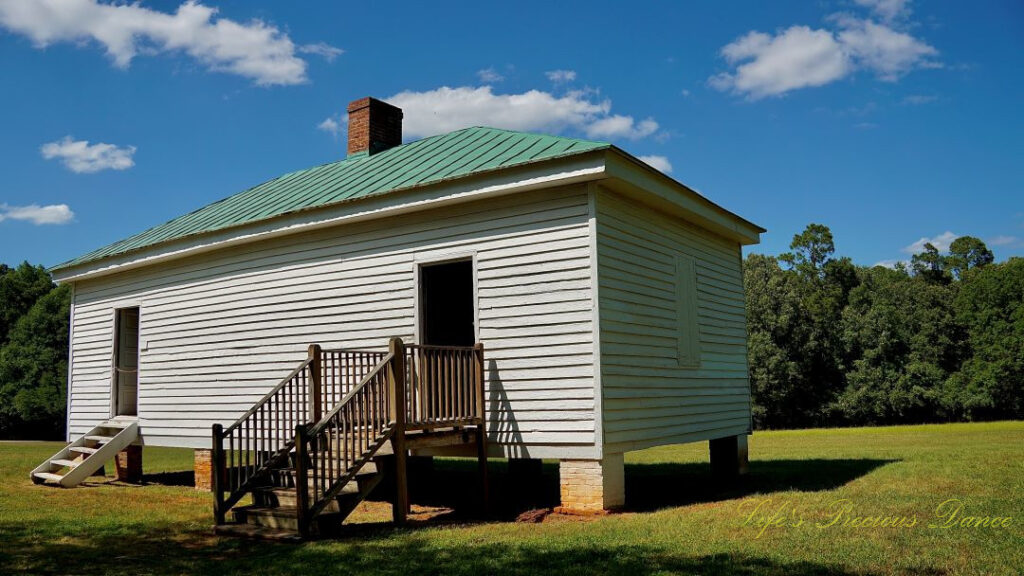 Outside view of slave quarters at Redcliffe Plantation Historic Site. Passing clouds overhead.