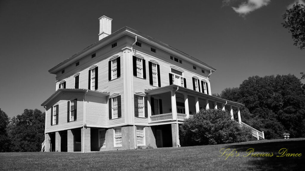 Black and white looking upward at the Redcliffe Plantation mansion.