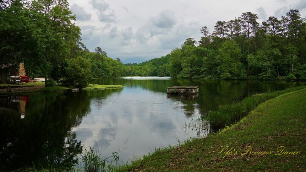 Landscape view of the Old Levi mill pond at Poinsett State Park. CLouds and surrounding trees reflecting on the water&#039;s surface.